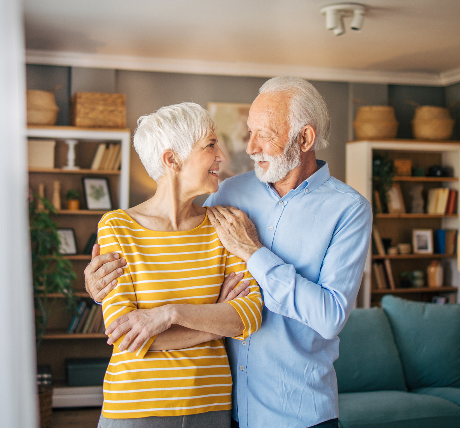 Happy senior couple embracing in their home